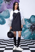 Stylera model wearing black white layered dress over printed bell sleeve tee with knee socks and sneakers