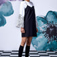 Stylera model wearing black white layered dress over floral bell sleeve top with knee socks