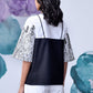 Back view of Stylera black white layered top with floral printed wide sleeves and contrast panel
