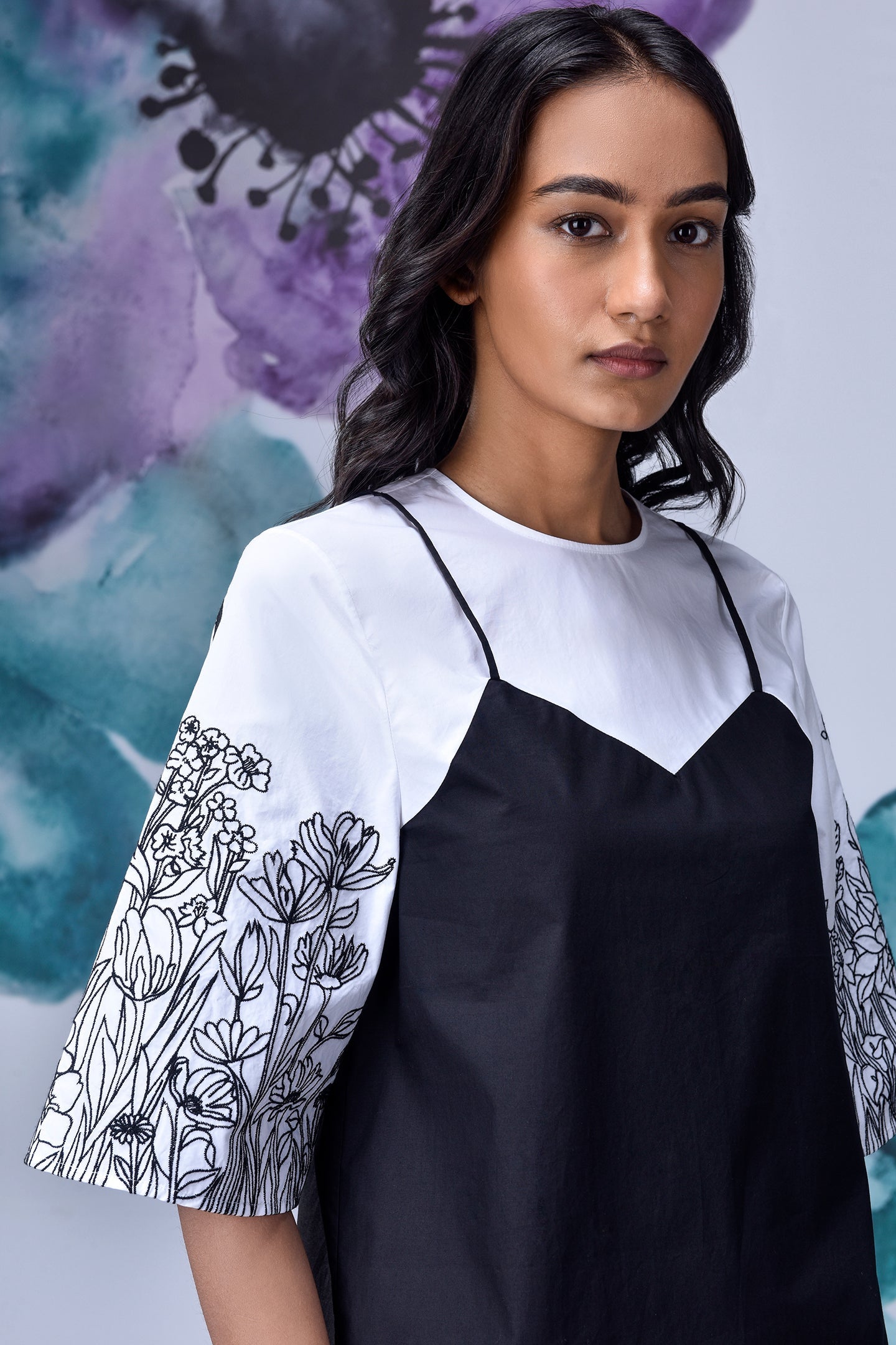 Stylera model wearing black white layered top with floral print wide sleeves and round neck
