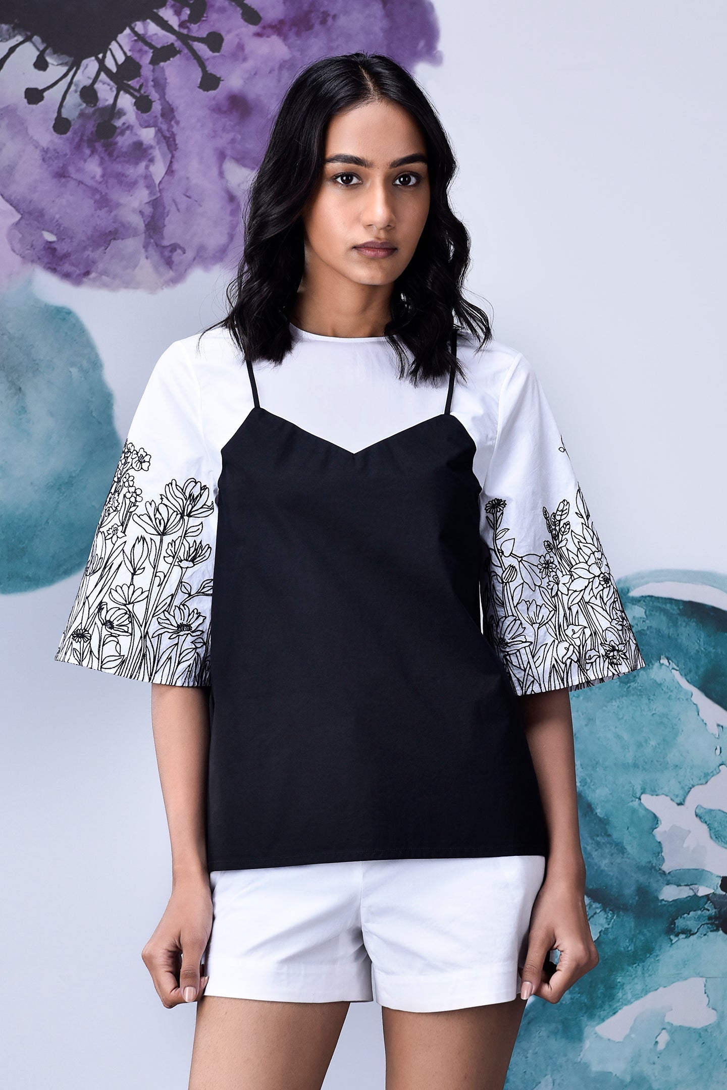 Stylera black white layered top with floral print bell sleeves worn with white shorts