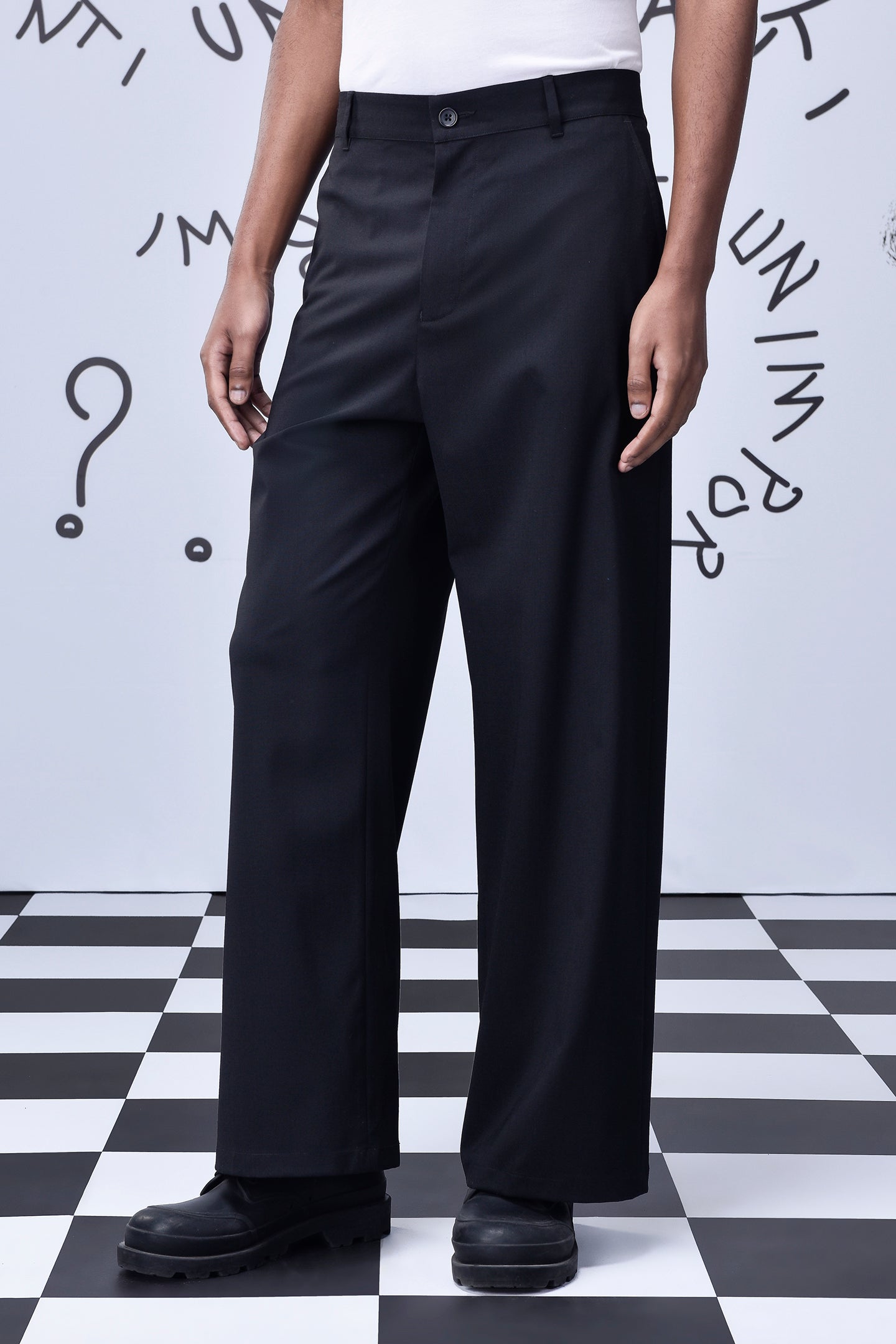 Stylera black wool straight fit trousers on model with white top and black chunky boots