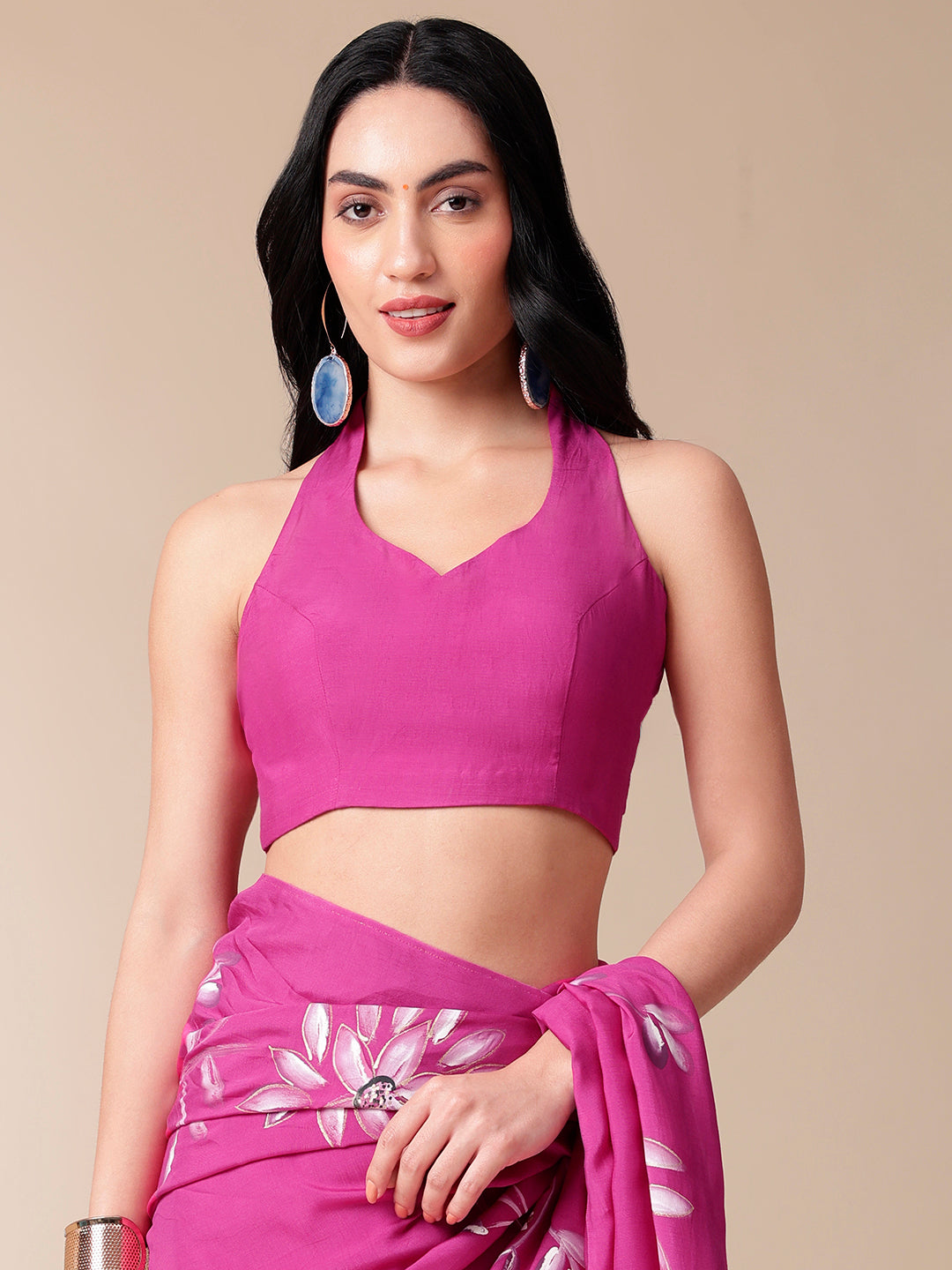 Model wearing a blissful brush pink silk saree paired with a matching halter neck blouse