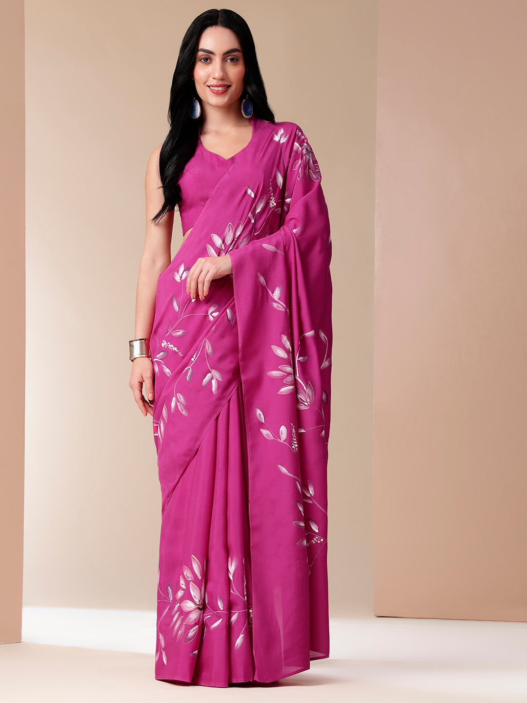 Stylera blissful brush pink silk saree featuring elegant floral designs and a graceful drape