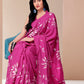Elegant woman wearing a blissful brush pink silk saree with floral patterns, perfect for special occasions