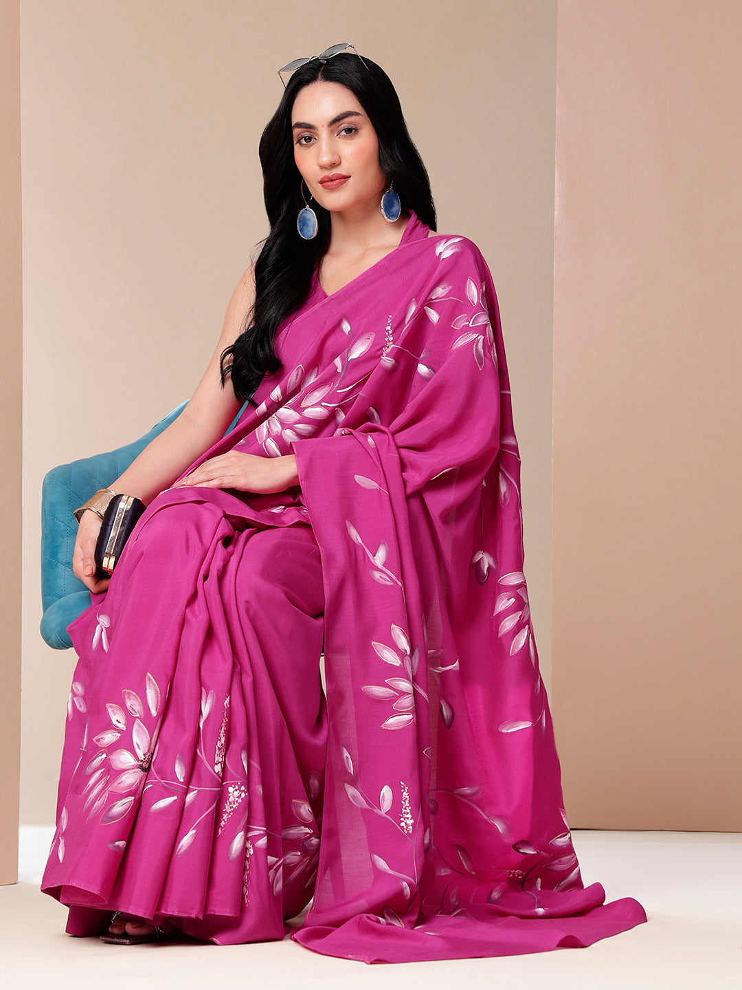 Elegant woman wearing a blissful brush pink silk saree with floral patterns, perfect for special occasions
