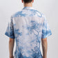 Back view of man wearing Stylera blue and white printed casual shirt short sleeve button down relaxed fit