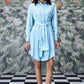 Model wearing Stylera blue green stripe dress shirt style with tie belt and embroidered chest
