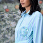 Model wearing Stylera blue green stripe dress with shirt collar cinched waist and embellished pocket