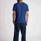 Back view of man wearing blue jacquard regular fit t-shirt paired with dark jeans