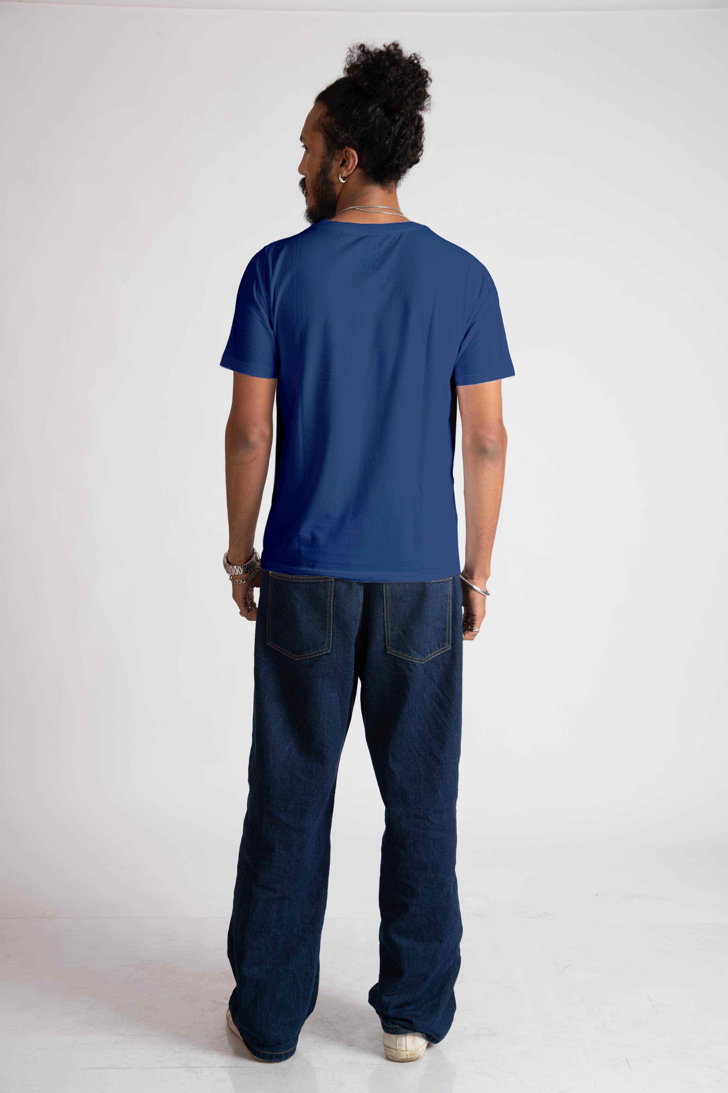 Back view of man wearing blue jacquard regular fit t-shirt paired with dark jeans