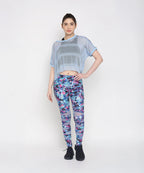 Blue netted top for women paired with vibrant floral leggings for a stylish workout look