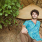 Stylera blue oversize shirt for men with a vibrant pattern, styled casually outdoors