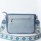 Stylish blue sling bag for women with an adjustable strap and zipper pocket on the back