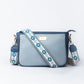 Stylish blue sling bag for women with decorative strap and sleek design