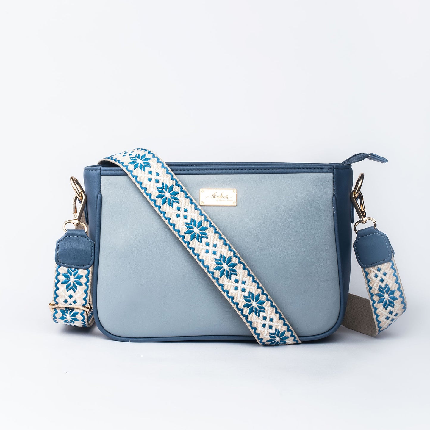 Stylish blue sling bag for women with decorative strap and sleek design