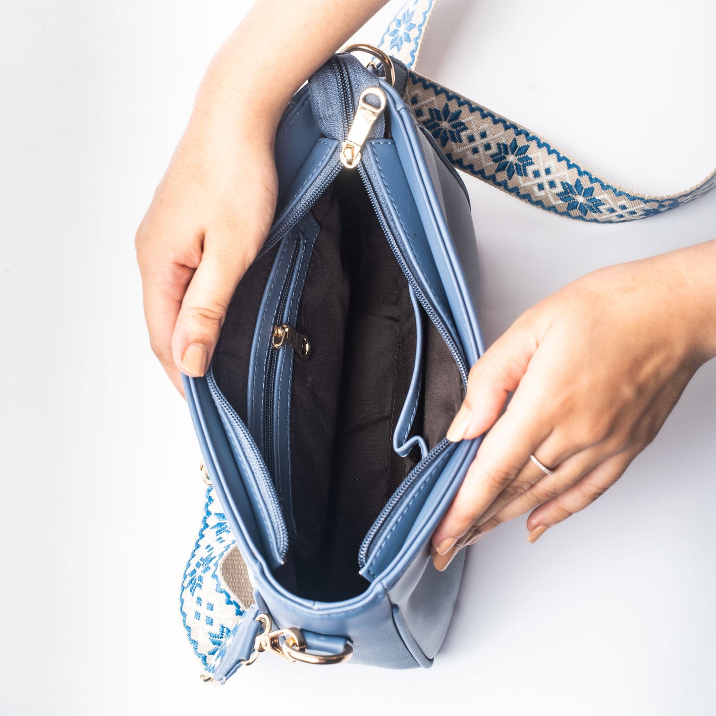 Interior view of a stylish blue sling bag for women with spacious compartments and elegant design