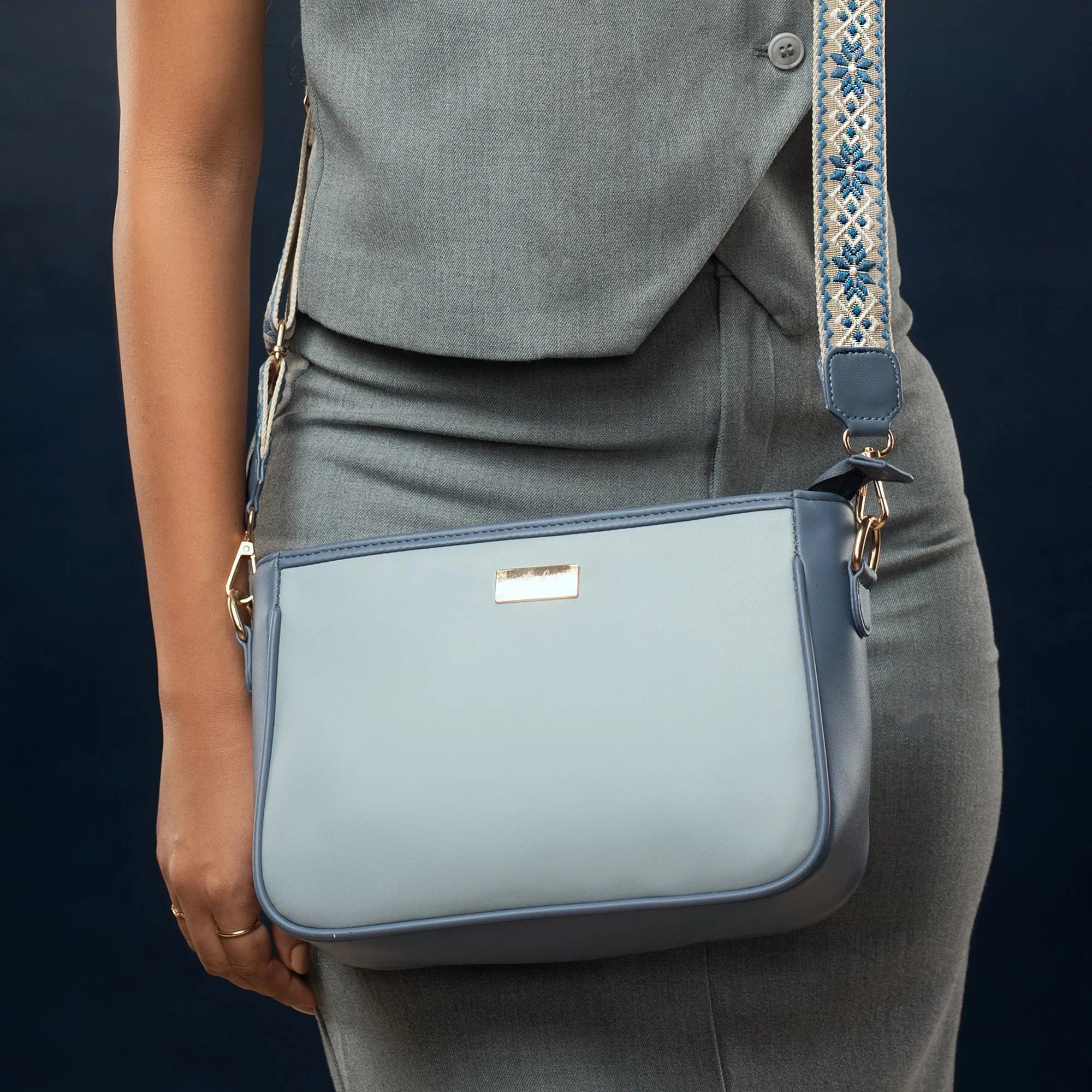 Stylish blue sling bag for women with decorative strap and sleek design for everyday use