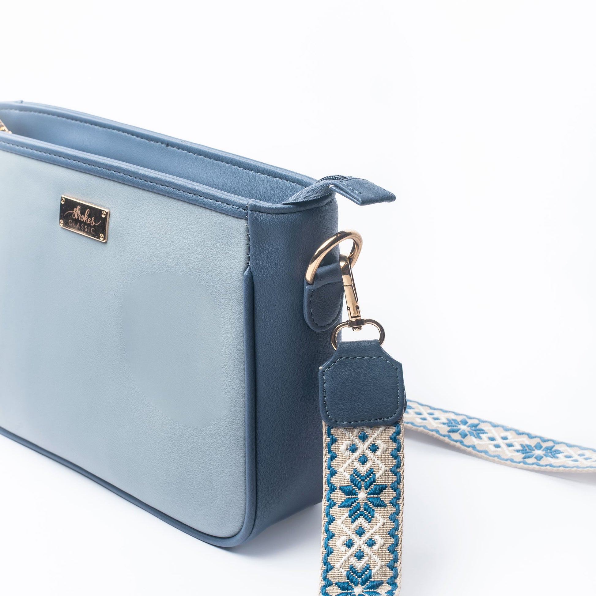 Stylish blue sling bag for women by Stylera with decorative strap and sleek design