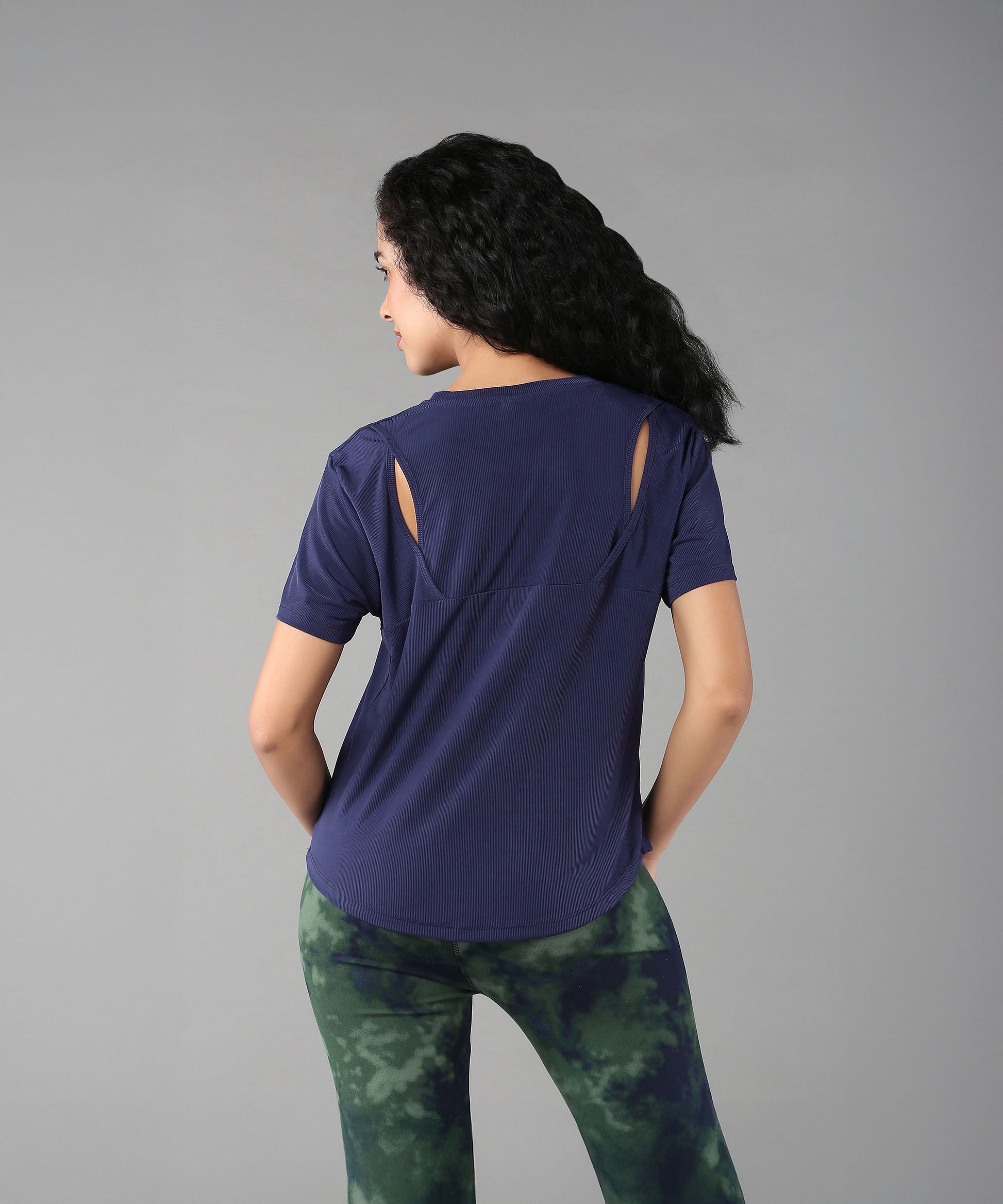 Women wearing a blue soft t-shirt for women with stylish cutout details on the back