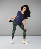 Active model wearing a blue soft t-shirt for women paired with stylish leggings and sneakers