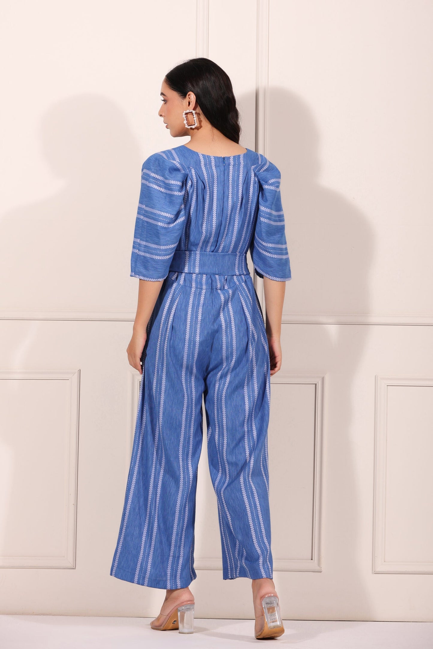 Back view of a blue striped jumpsuit for women with stylish puff sleeves and a fitted waist
