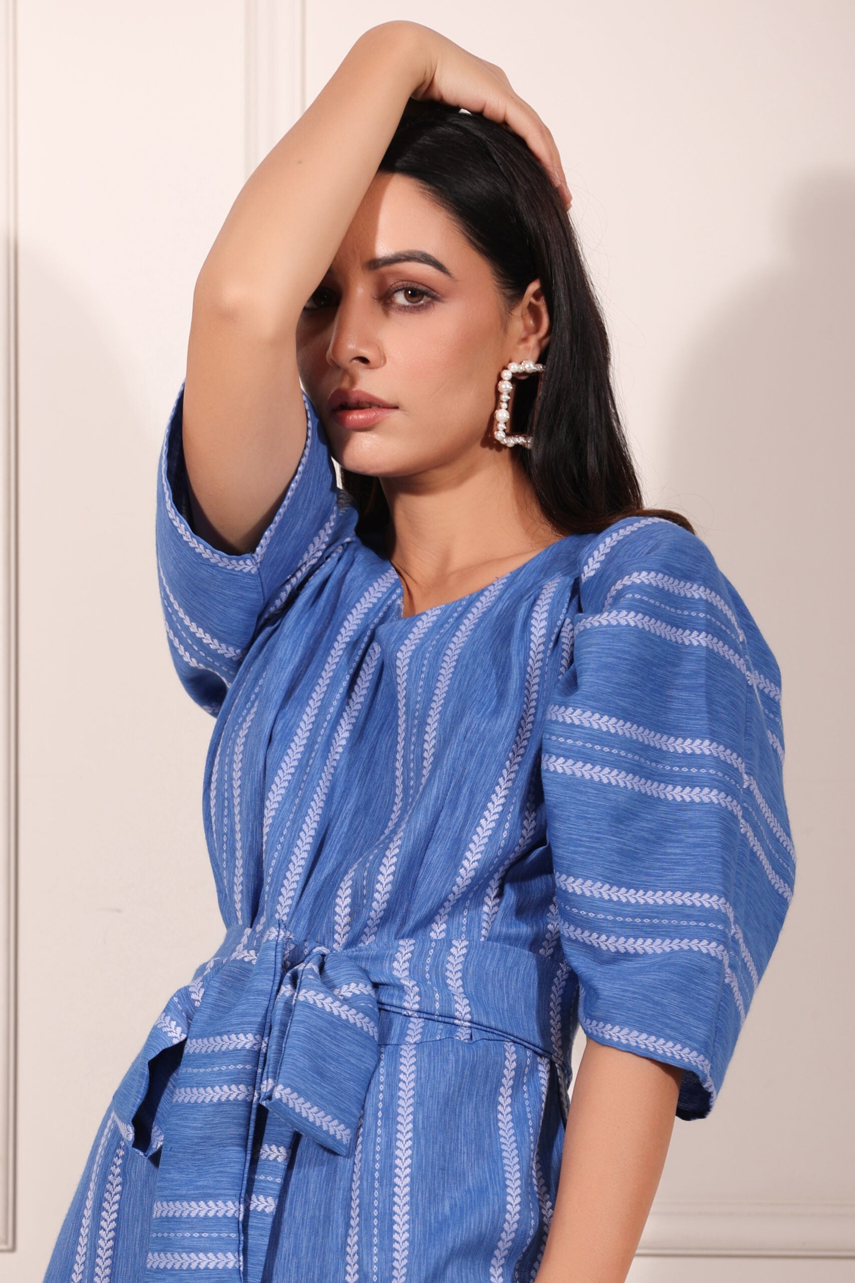 Elegant blue striped jumpsuit for women with puff sleeves and a belted waist