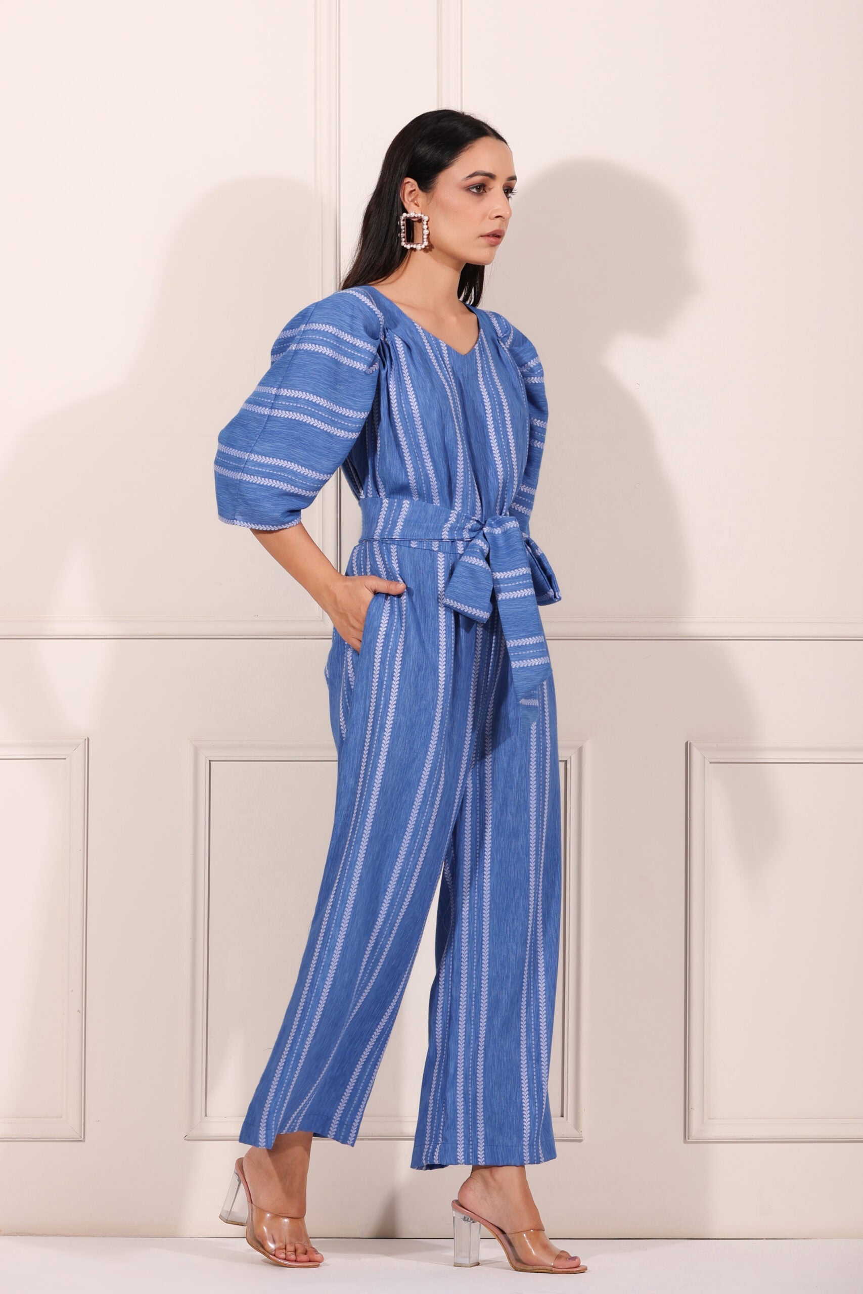 Stylish blue striped jumpsuit for women with puff sleeves and a tie belt for a chic look