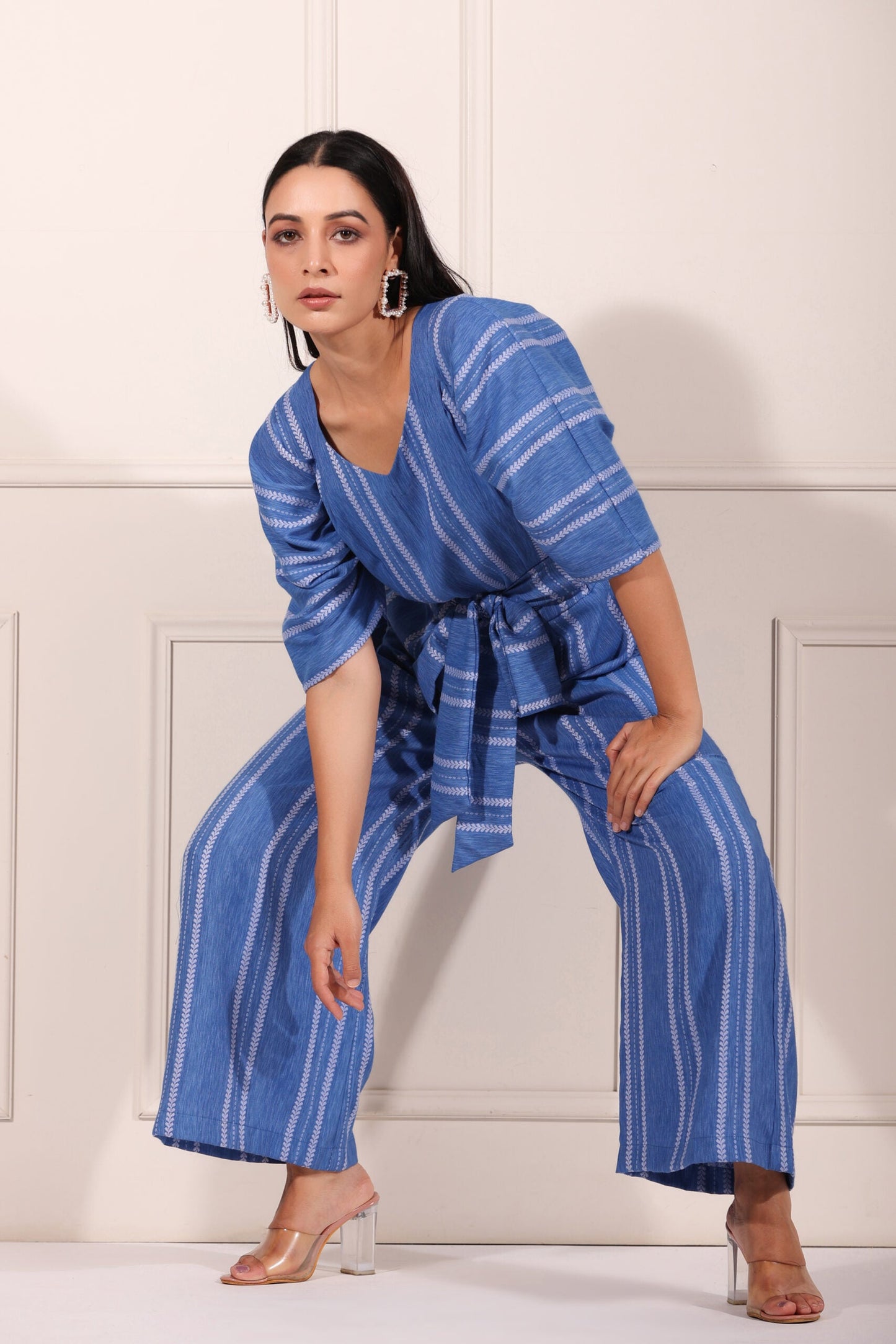 Stylish blue striped jumpsuit for women with a waist tie, perfect for casual outings