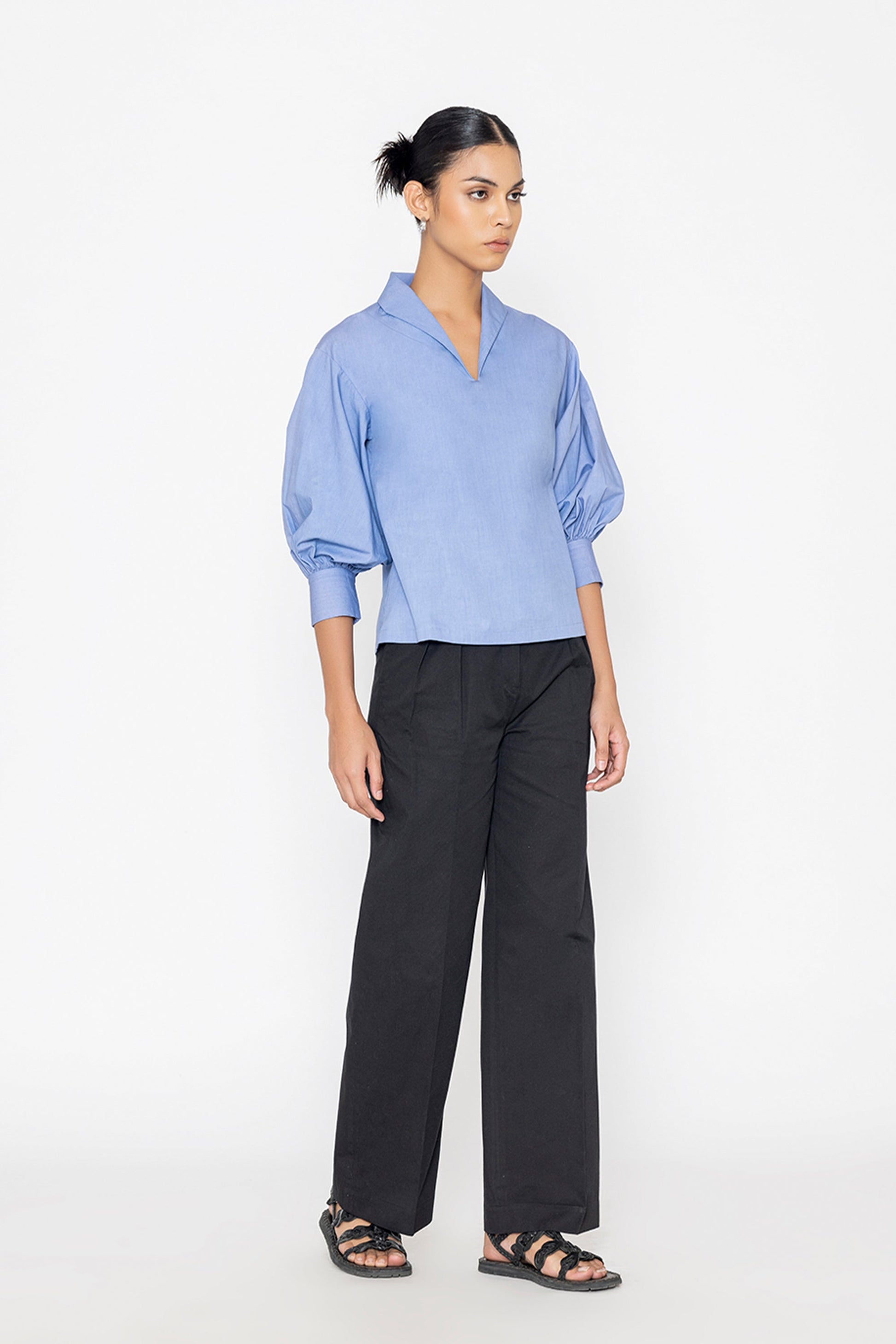 Stylera blue v neck blouse with puff sleeves paired with black wide leg pants