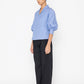 Stylera blue v-neck blouse with puffed sleeves paired with black wide-leg pants
