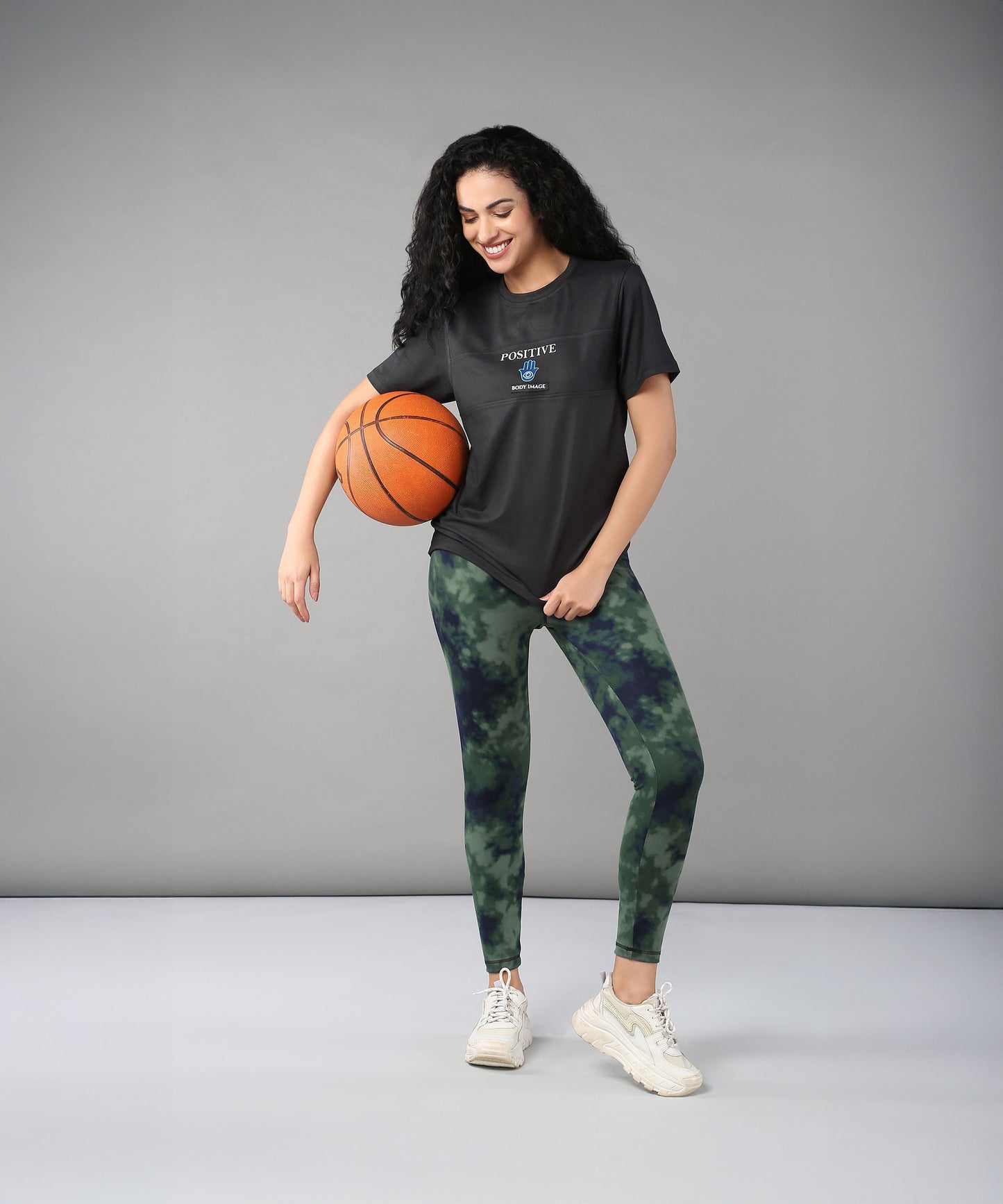 Stylera body positivity clothing for women featuring a stylish black t-shirt and green tie-dye leggings