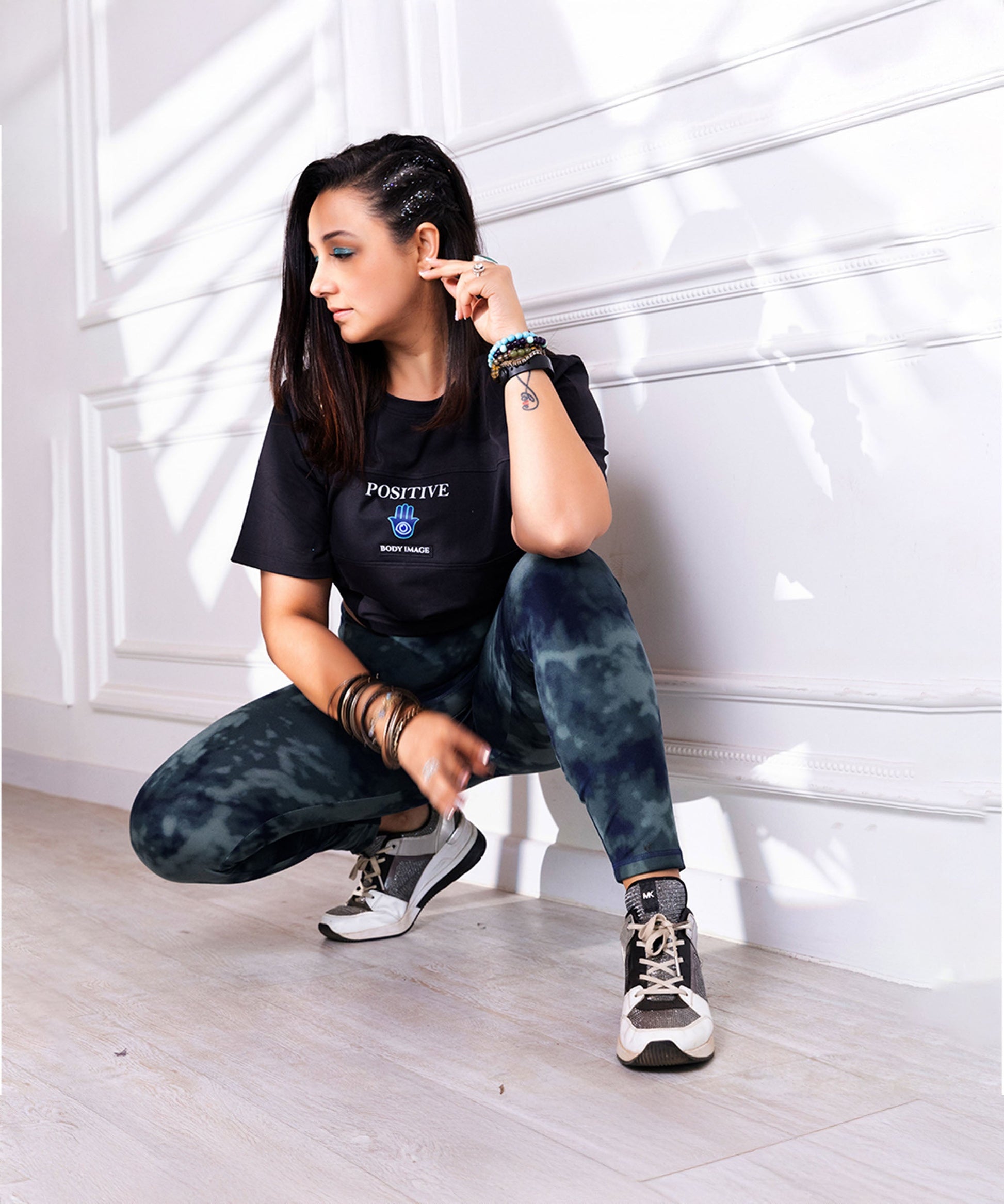 Woman in black Positive t-shirt and camo leggings from Stylera for body positivity clothing for women