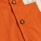 Close-up of Stylera boho charm short sleeve shirt in vibrant orange with wooden buttons