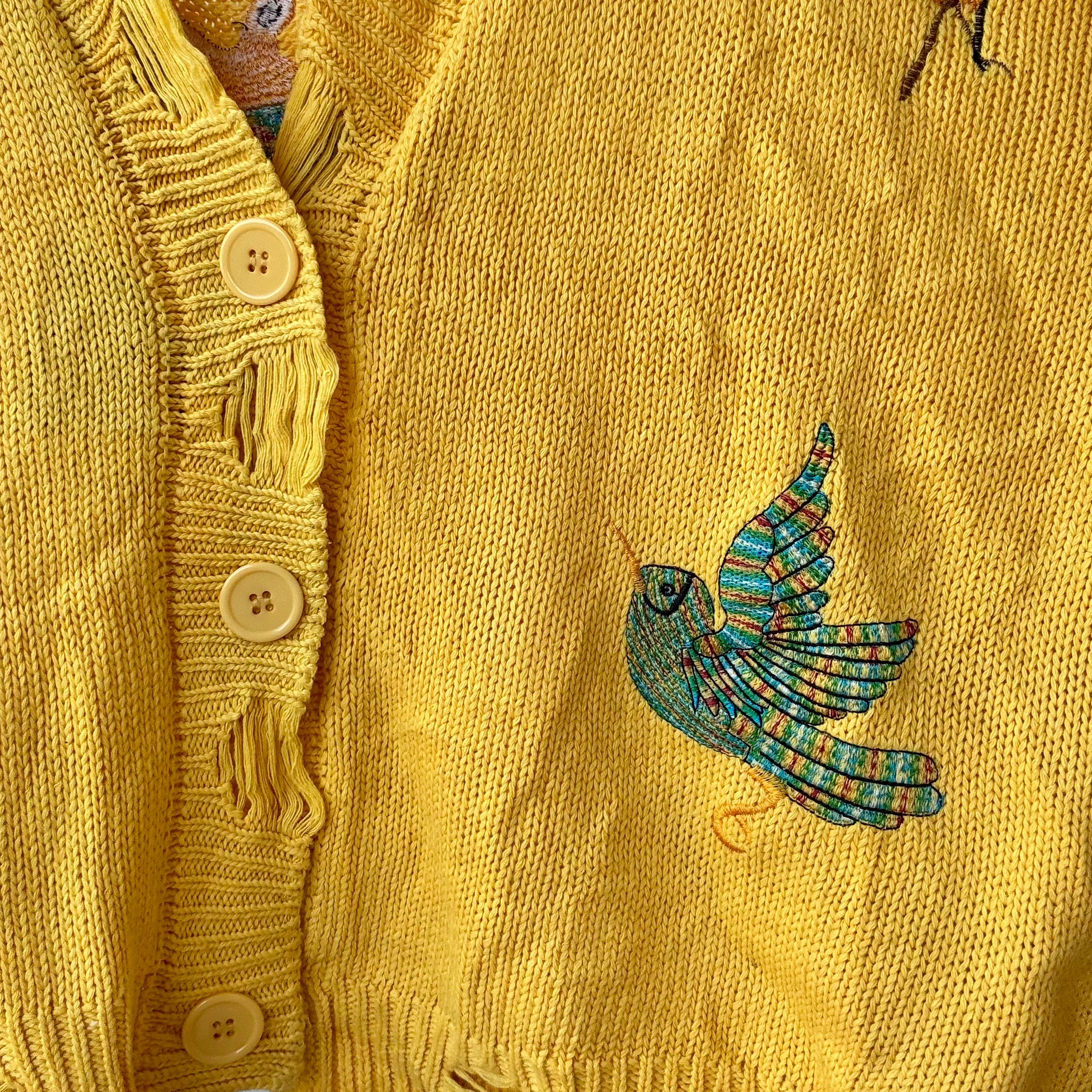 yellow knit sweater for women from Stylera featuring button front and embroidered bird detail