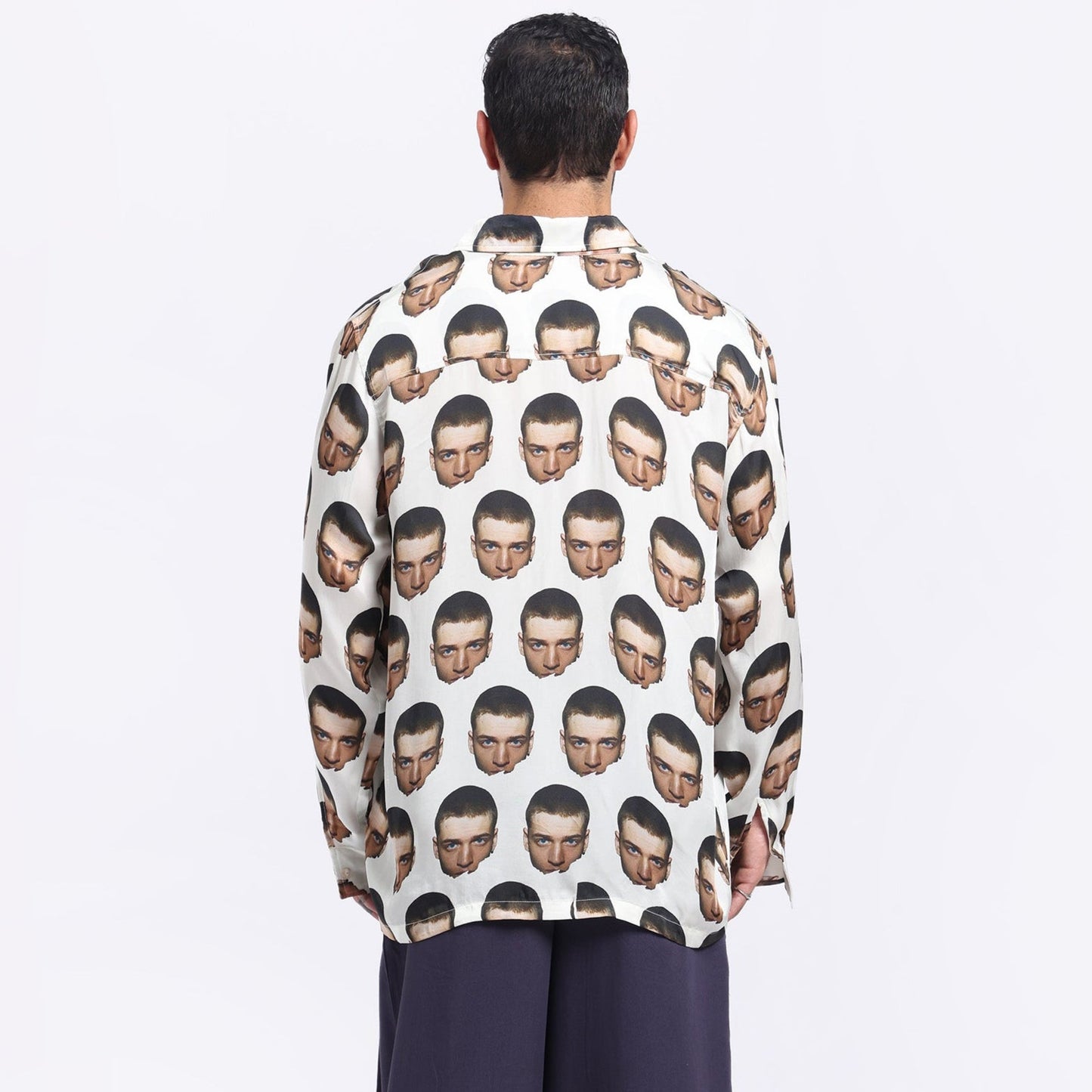 Stylera bold print casual shirt featuring unique face patterns on a light background