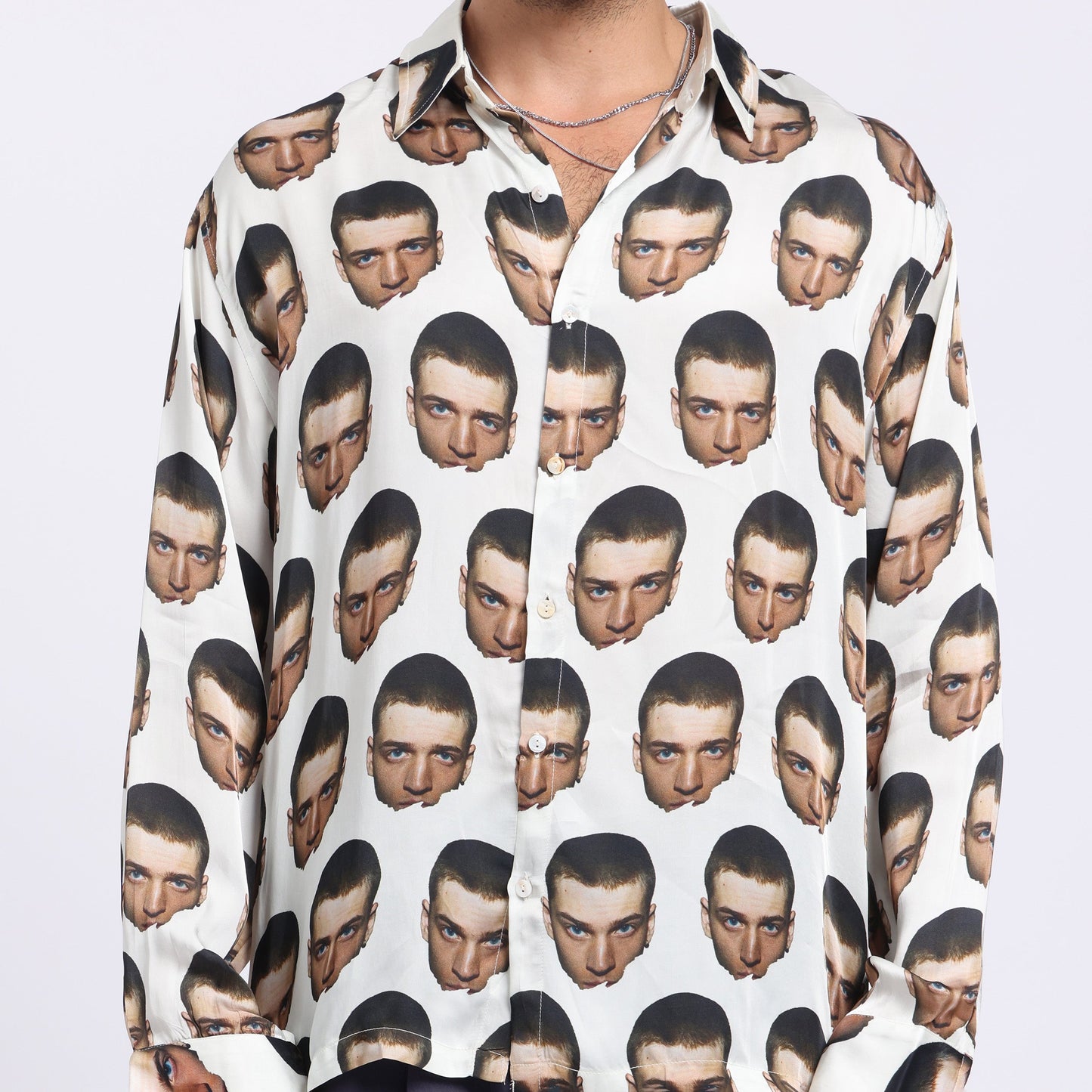Stylera bold print casual shirt featuring a unique pattern of stylized faces on a light background