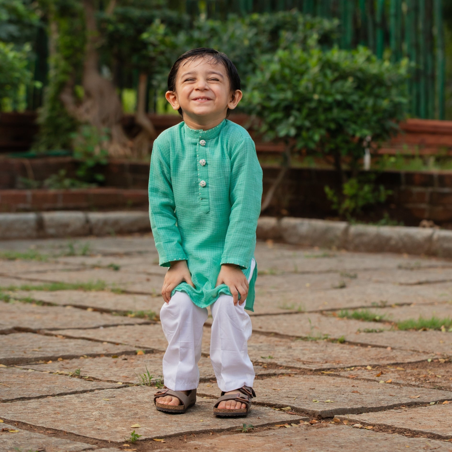 Boys festive kurta pajama set in green with buttons, perfect for special occasions