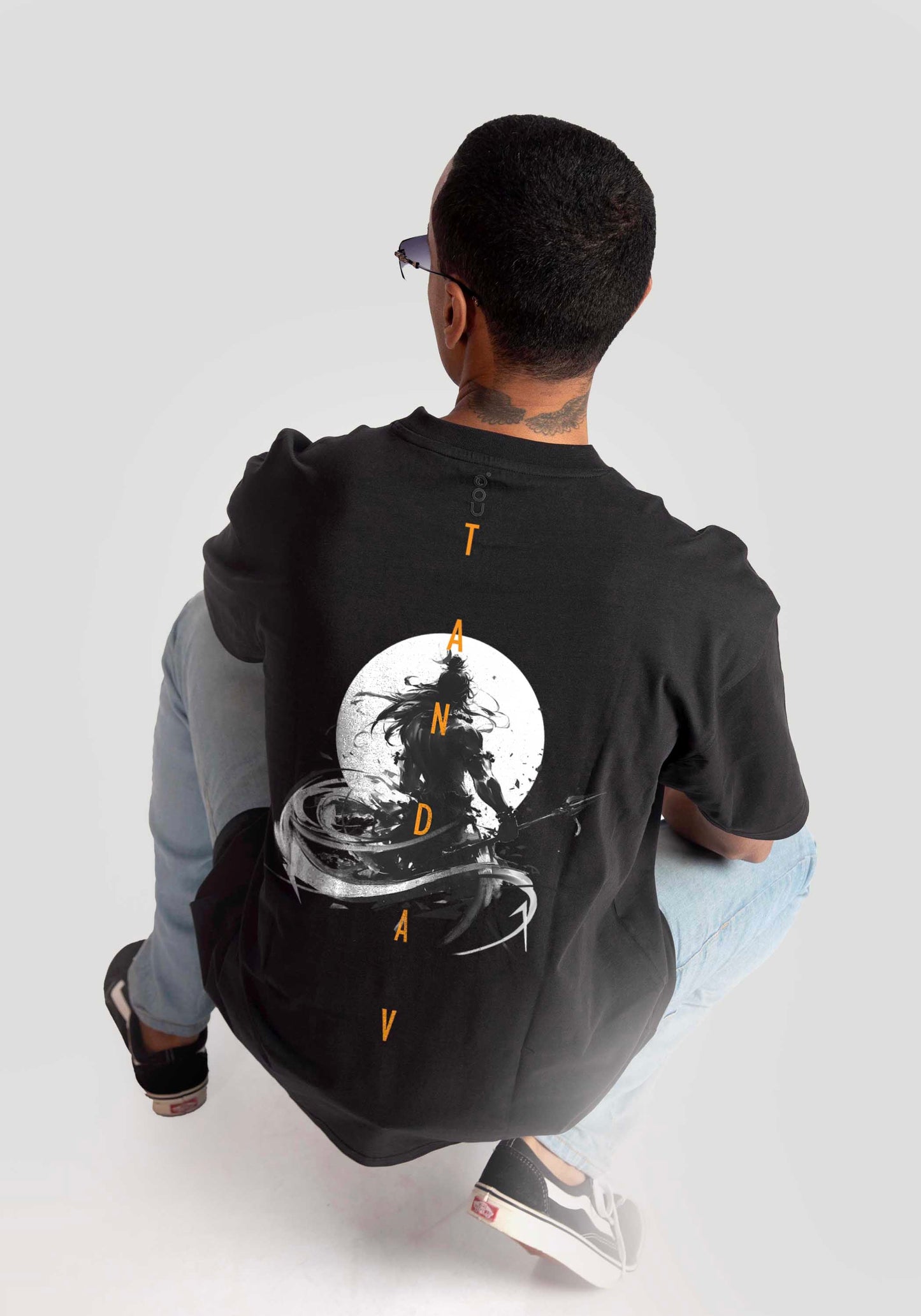 Stylera Lifestyle charcoal black oversized t-shirt with graphic design worn by seated man