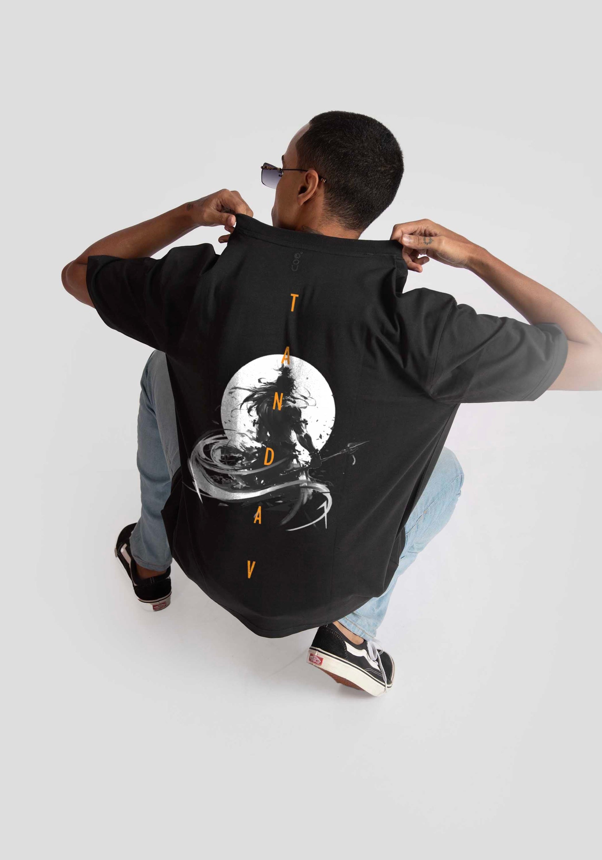 Stylera Lifestyle charcoal black oversized t-shirt with graphic moon and text design worn by a crouching model