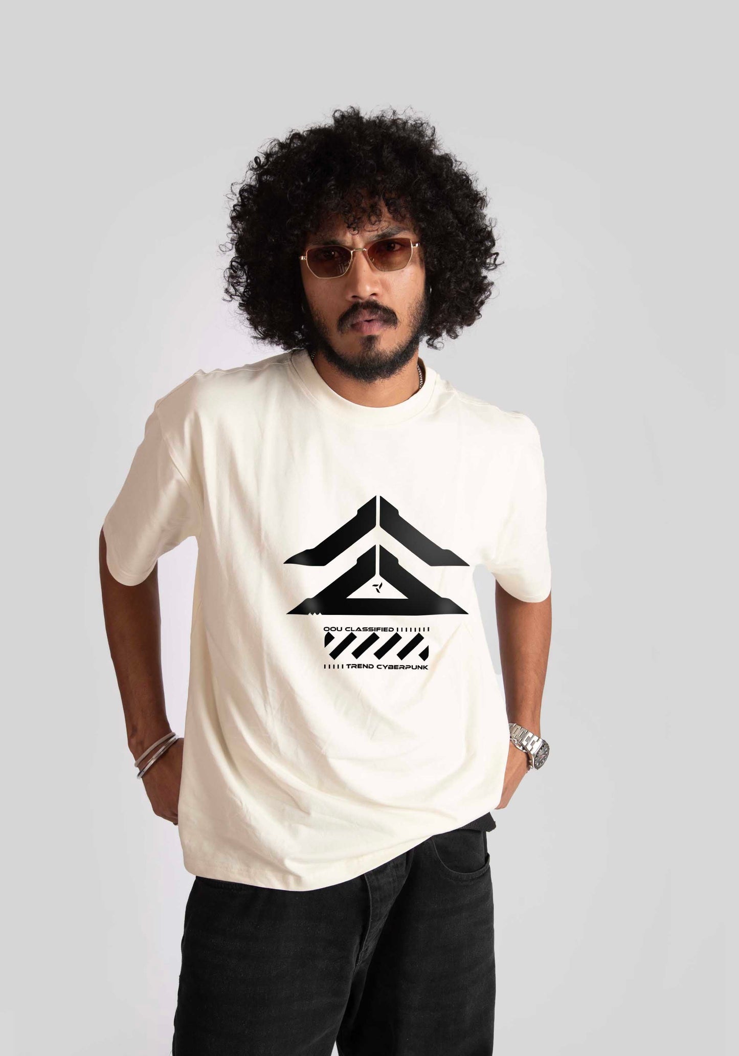 Stylera cyberpunk oversized t-shirt in white with black futuristic graphic worn by man with curly hair and sunglasses