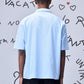 Back view of a man wearing a light blue relax fit shirt for men by Stylera