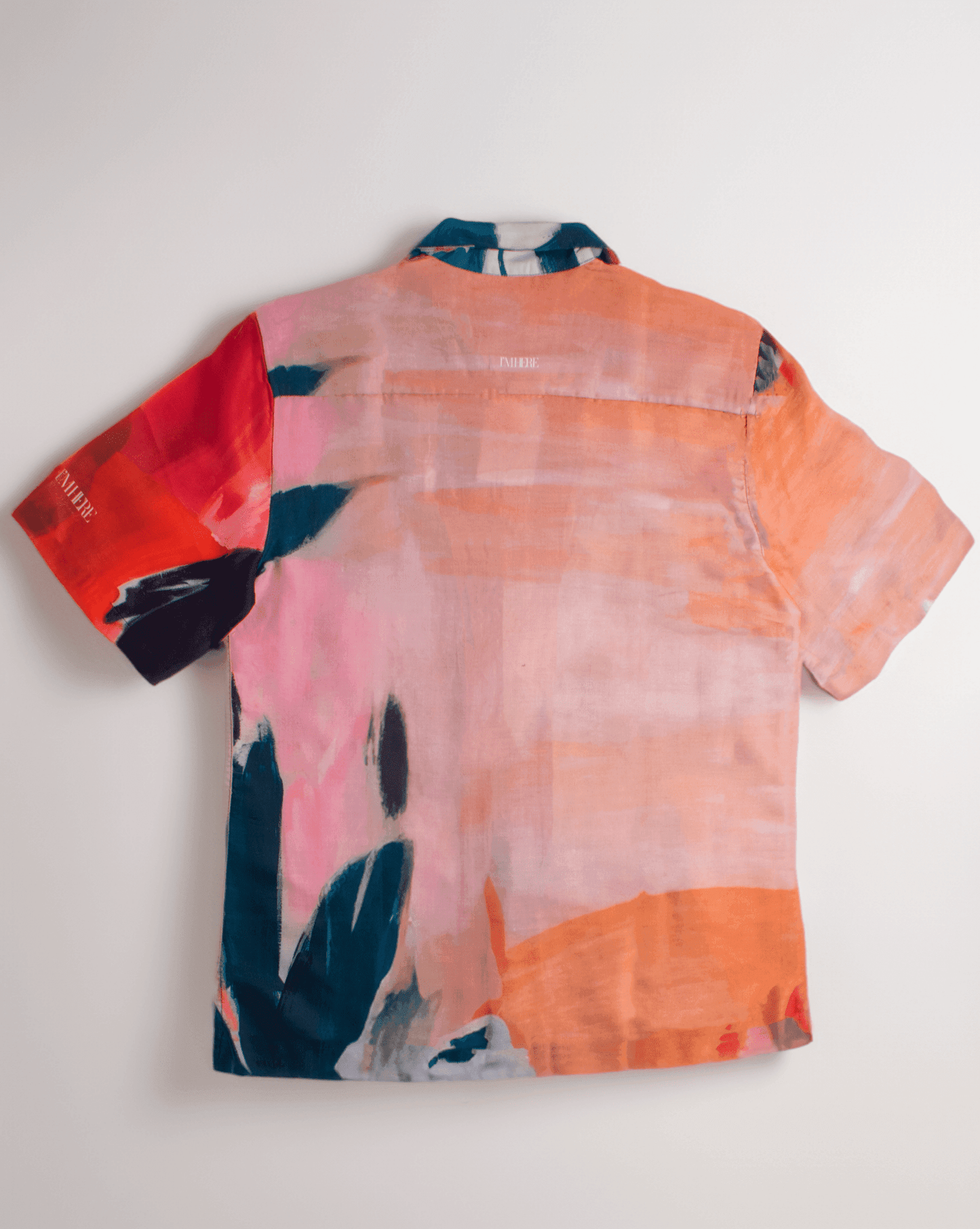 Back view of Stylera men's printed resort shirt in coral pink orange and navy abstract watercolor print