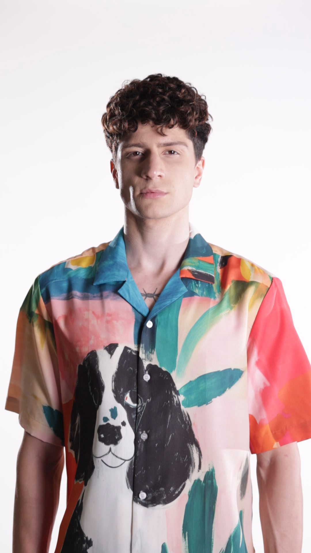 Stylera men's printed resort shirt on male model with colorful tropical print and large dog illustration