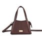 Stylish brown mini purse for women with a sleek design and adjustable strap by Stylera