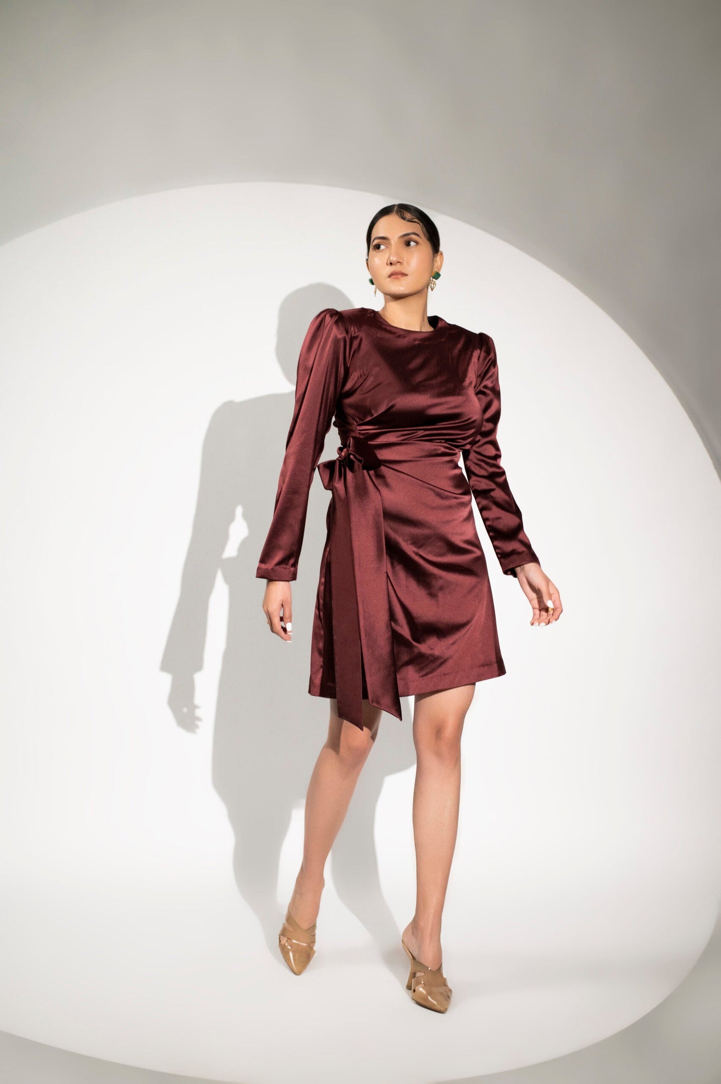 Burgundy satin party dress with long sleeves and a wrapped design for elegant occasions