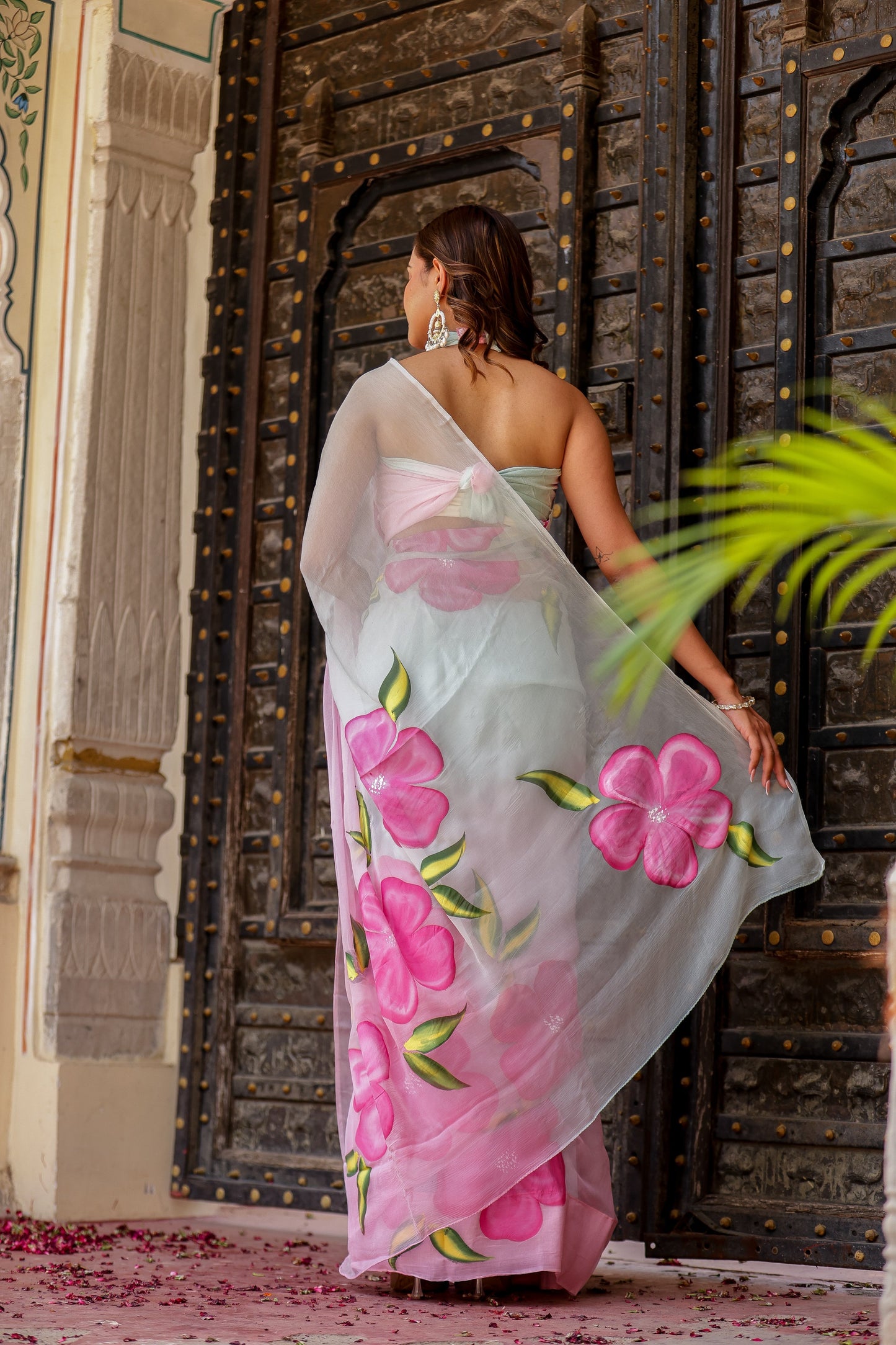 Elegant woman in a pastel chiffon saree with floral prints, perfect to buy trendy chiffon saree