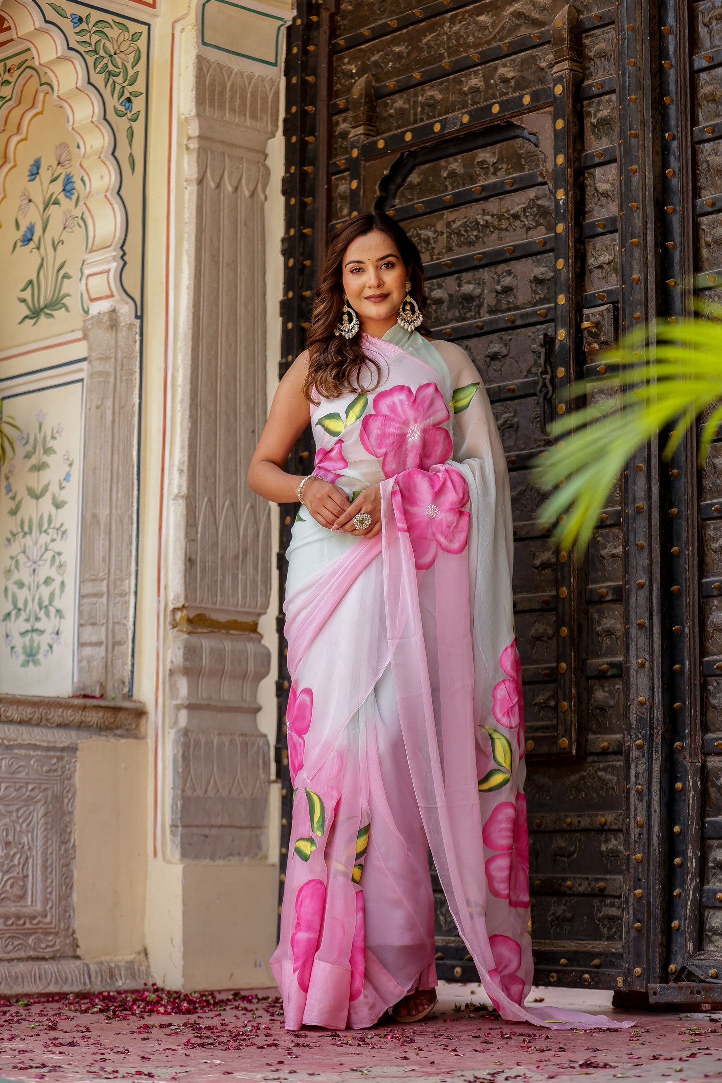 Elegant woman wearing a pink floral design chiffon saree from Stylera to buy trendy chiffon saree