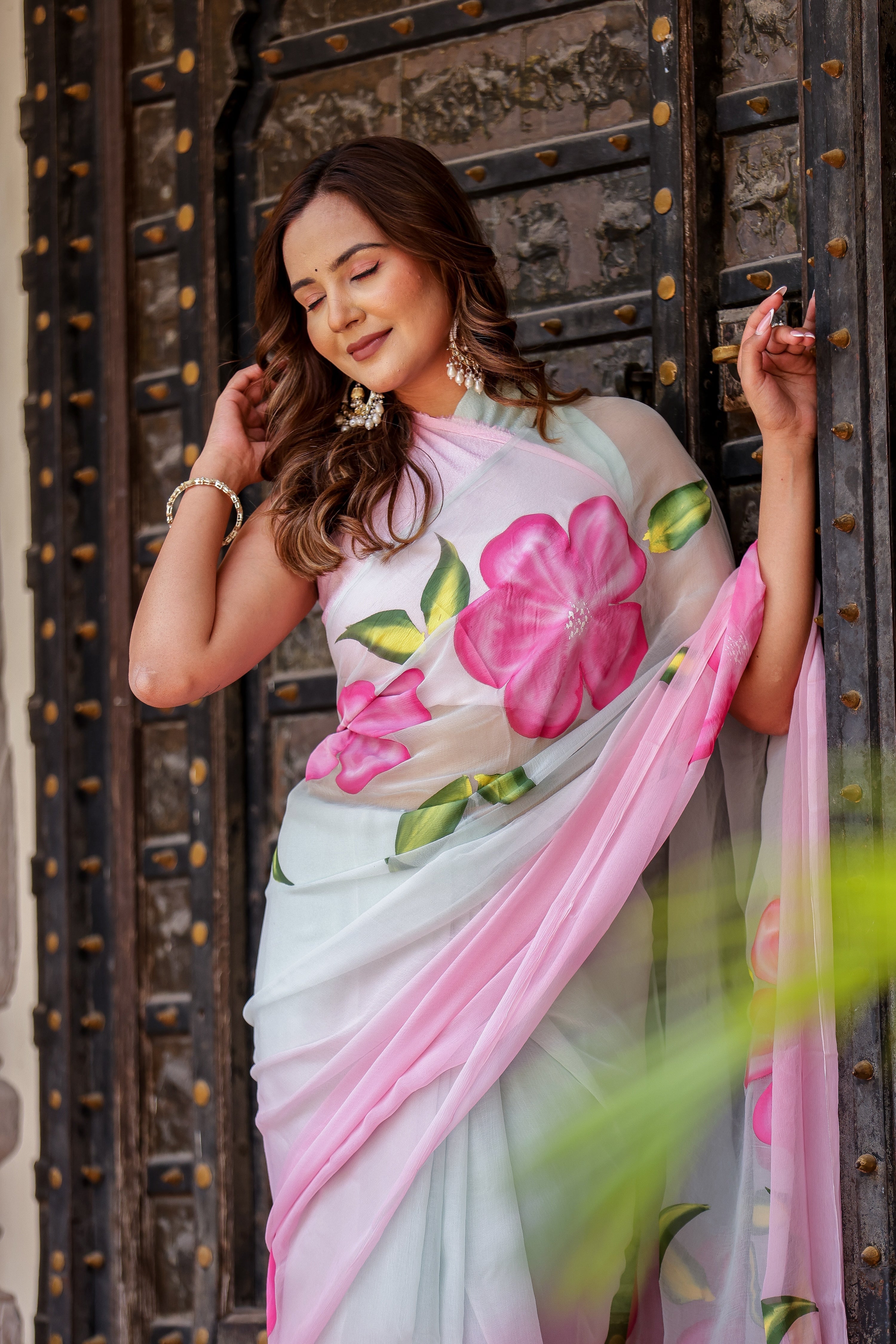 Elegant woman in a floral chiffon saree showcasing style and grace, perfect to buy trendy chiffon saree.
