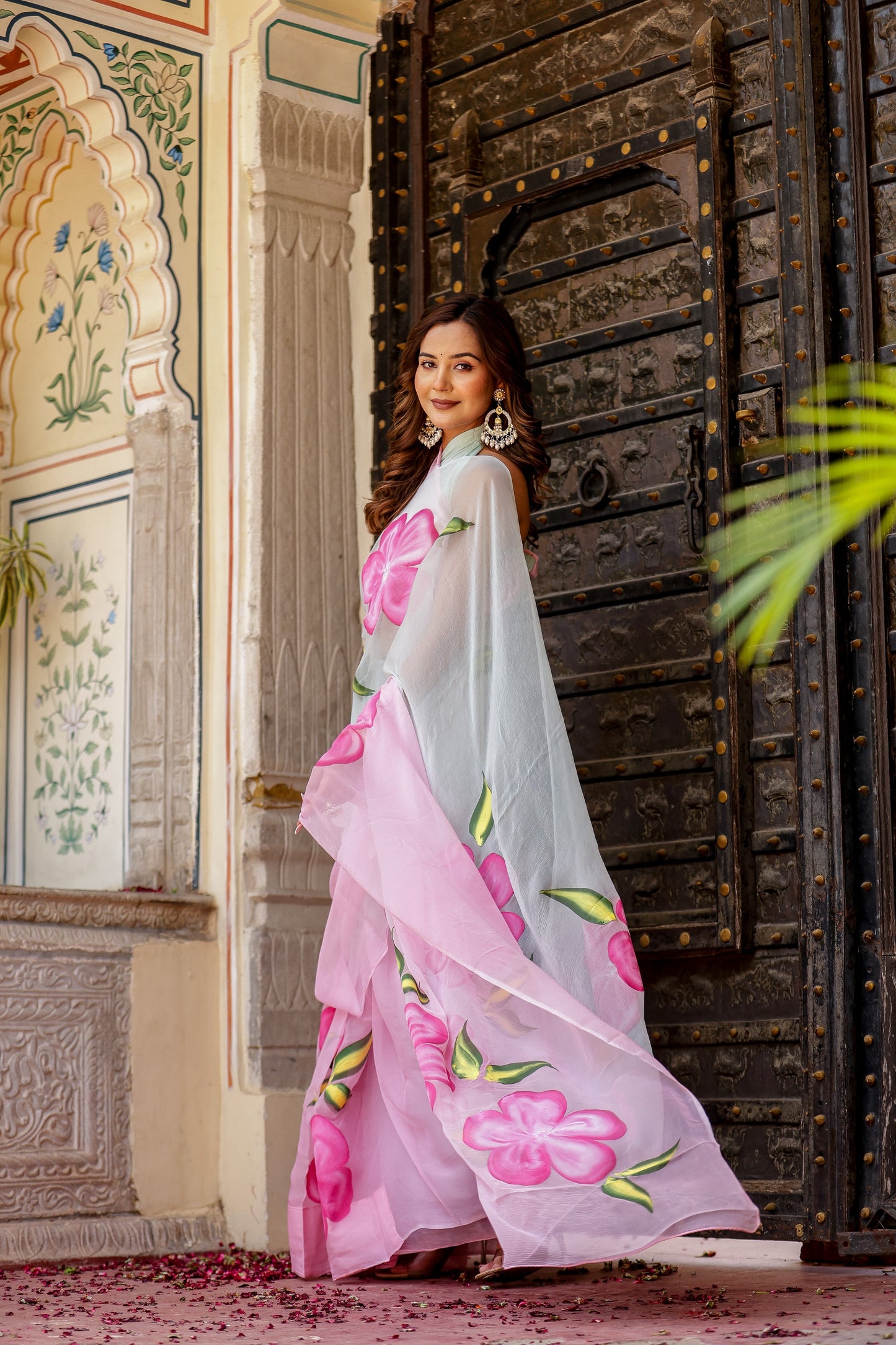 Stylish woman in a pink and grey trendy chiffon saree for elegant occasions. Buy trendy chiffon saree.